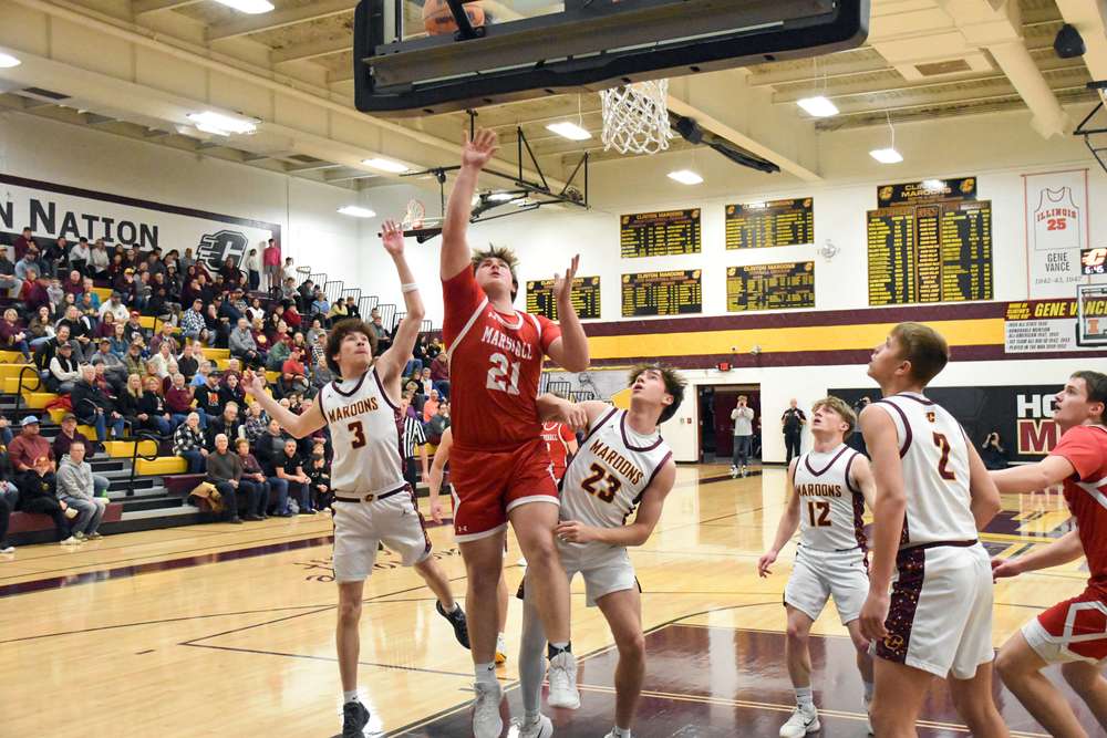 Garrett Pugh (21) finished with 21 points and 10 rebounds while being double teamed by Clinton