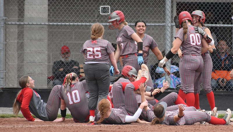 Marshall celebrates McKenzie Davis' home run against Paris at home plate