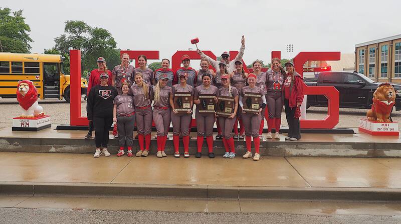 Marshall's softball team and coaches celebrate with all four regional championship plaques