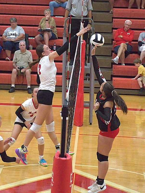 Lilly Ross (2) wins the point at the net during Marshall's straight set win over Chrisman