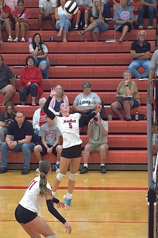Marshall outside hitter Lauren English (5) readies to spike the ball against Chrisman