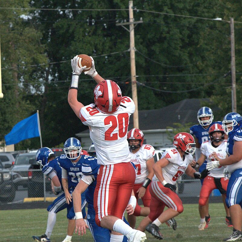 Marshall's Cooper Danke (20) goes up and catches a pass from Luke Brodie against Sparta