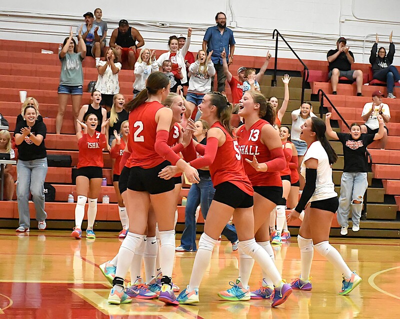 The Lions celebrate their come from behind three-set win over Dieterich