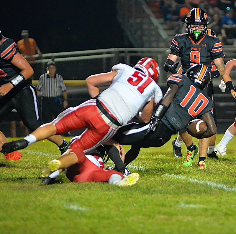 Marshall's Josef Stafford (51 brings down Paris' Kipton Bradford (10) with a vicious tackle during LIC action