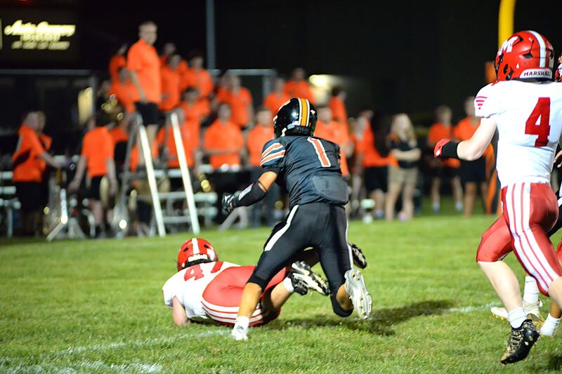Marshall's Wyatt Geltz (47) dives across the goal line to score a touchdown against Paris