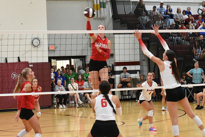 Lilly Ross goes up high over the net to score a kill against Lawrenceville