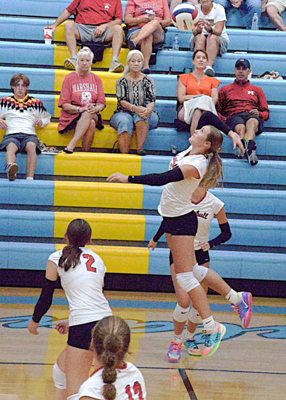 Lily Shotts (center) rises up to strike a kill versus Cumberland during Marshall's straight set win