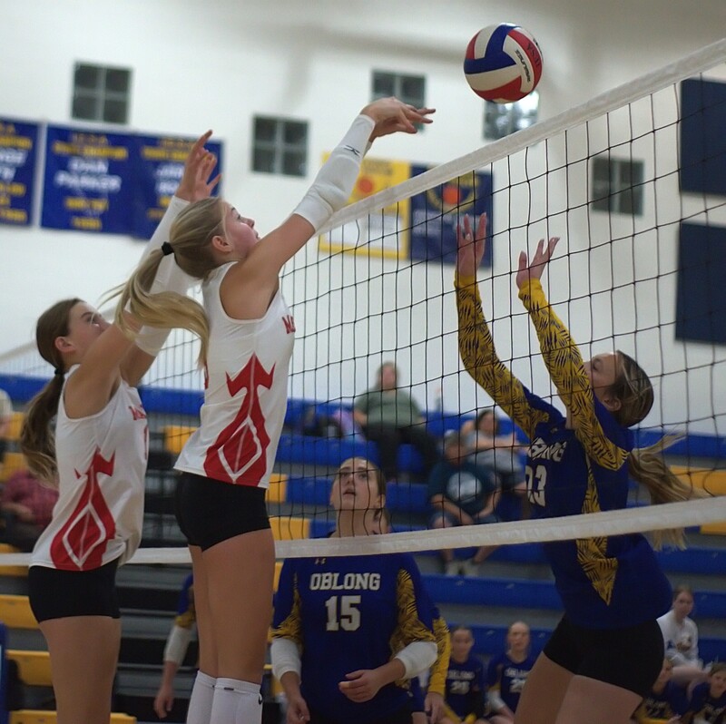Libby Huisinga (L) and Harper Richardson (R) battle Oblong at the net