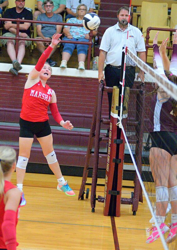Ellie Delp (10) strikes a kill against Mount Carmel during Marshall's straight set win