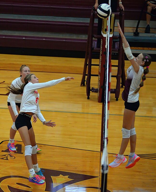 Marshall's Charlee Francis (6) threads a kill over the Mount Carmel block