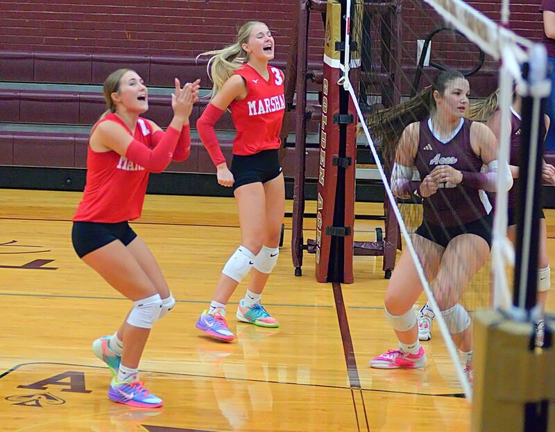 Lily Shotts (L) and Harper Richardson (R) celebrate Marshall winning the opening set at Mount Carmel (1)