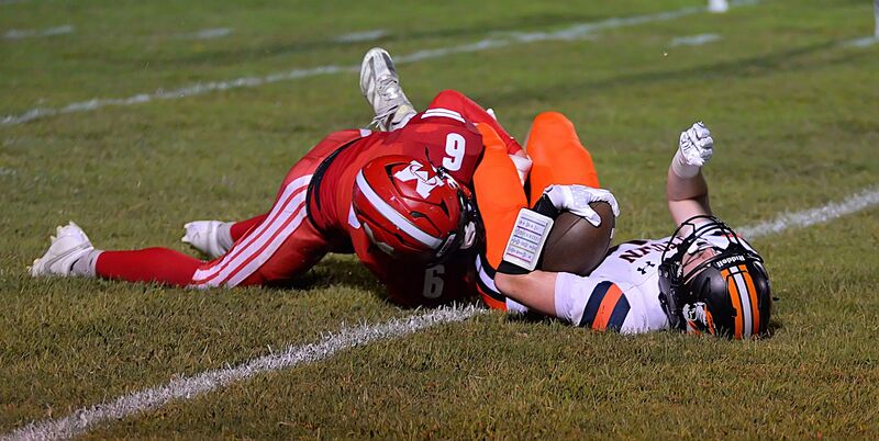 Bryce Parker (6) has no problem dropping the Richland County running back during LIC action at Bush Field
