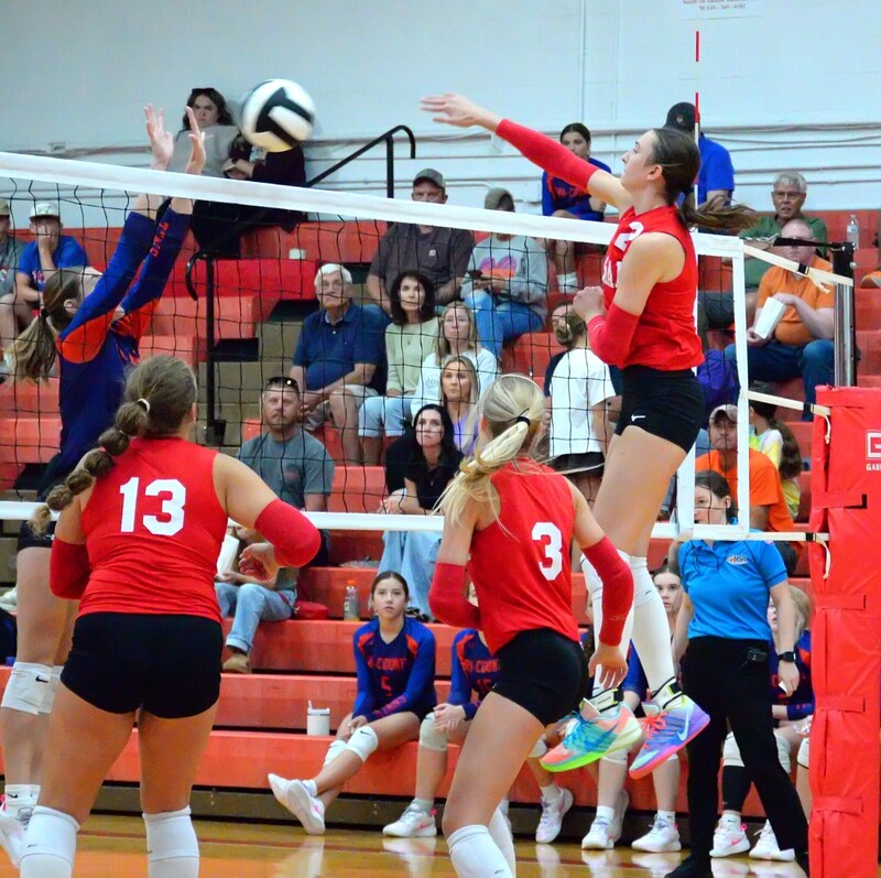 Lilly Ross goes head and shoulders above the net to drill a hit against Tri-County
