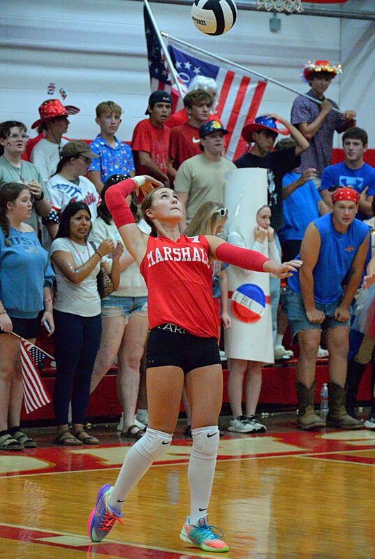 Lily Shotts serves for Marshall against St Anthony in fromt of the Lions student section
