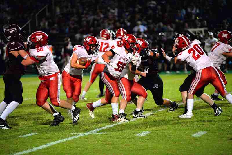 Marshall's David Sherrell (8) follows his blockers through the hole against Robinson