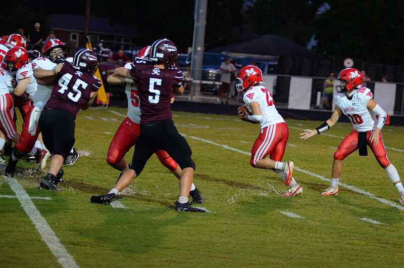 Max Welsh (23) gets good blocking up front for a Marshall first down at Robinson