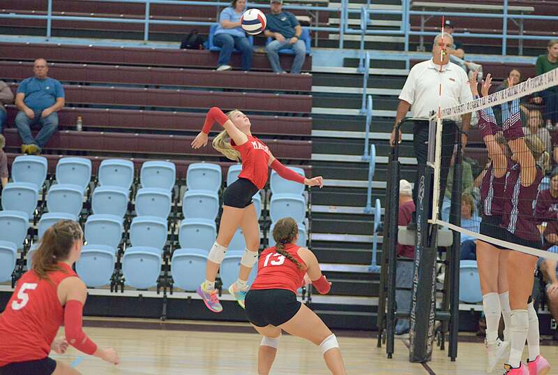 Harper Richardson gets ready to smash a kill through the St Joe-Ogden block during Marshall's win in straight sets