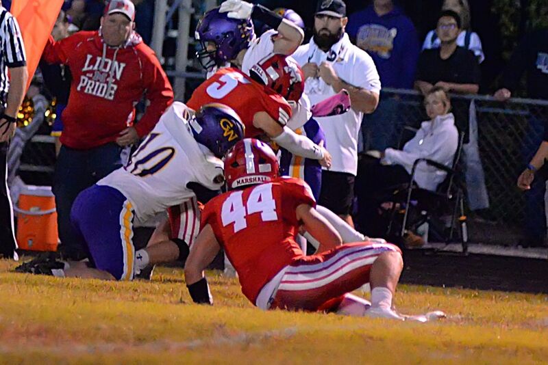 Eli Thompson (5) makes the tackle while he is being tackled by a blocker (1)