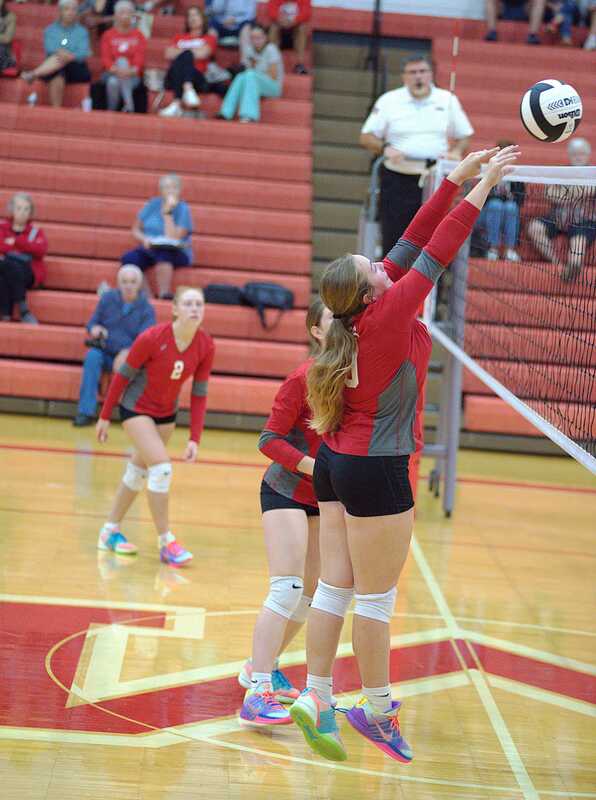 Aubrie Ockerman (10) blocks a strike and wins the point for Marshall against St John's Lutheran