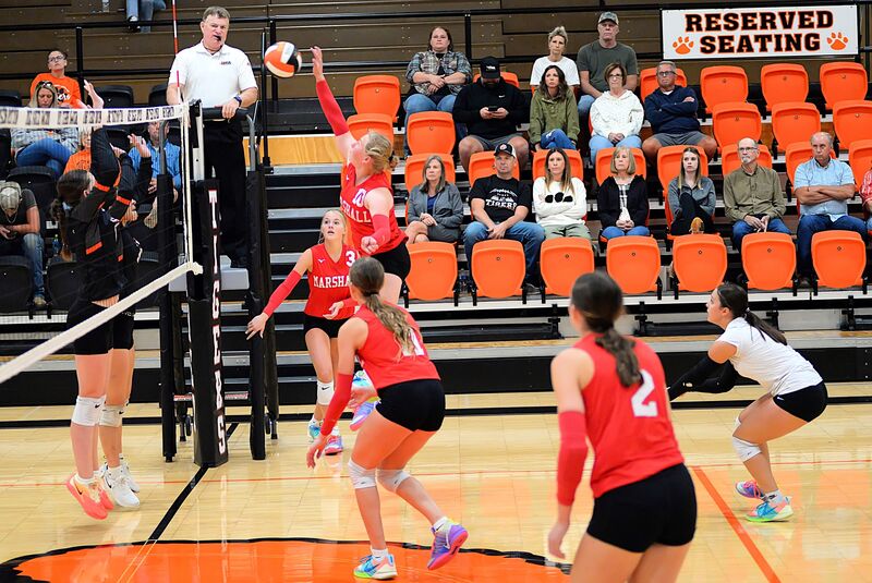 Ellie Delp (10) drives a kill past the Olney block during Marshall's win in straight sets
