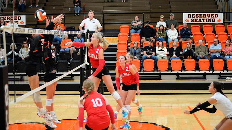 Harper Richardson (3) beats the Olney block at the net during Marshall's win