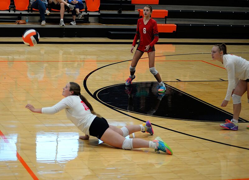 Marshall's Aubrie Ockerman dives and keeps the point alive against Olney in the JV match