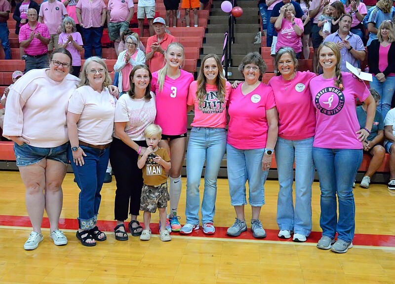 The Marshall Milkmaids accept a donation from Marshall Volleyball head coach Karlee McCollum and senior co-captain Harper Richardson