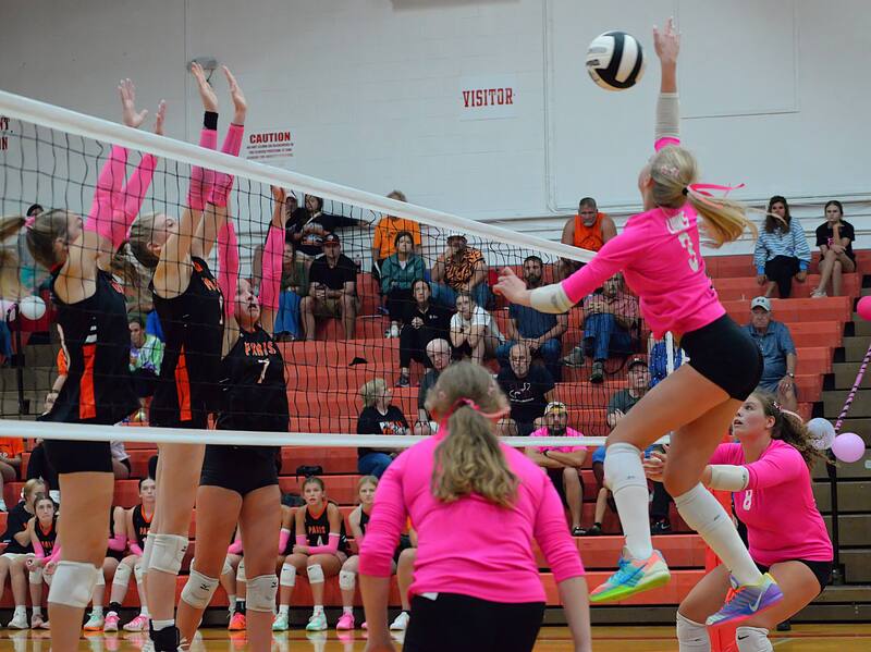 Harper Richardson (3) smashes a kill through the Paris block during Marshall's big win