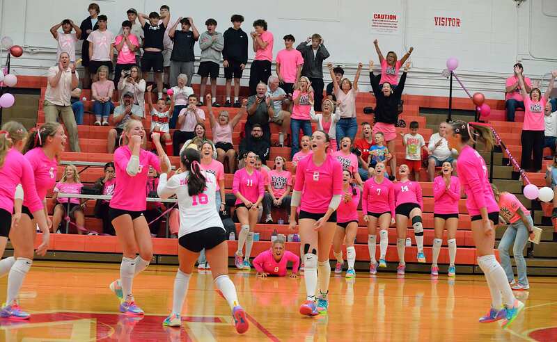 Marshall volleyball celebrates their comeback win in the third set against Paris as the Paris students stand in disbelief (1)