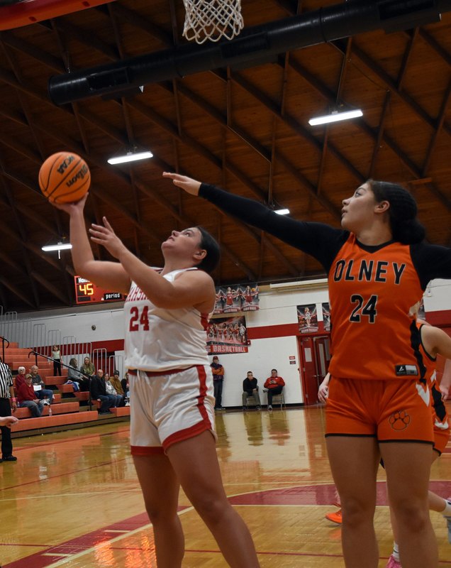 Ella Mattas (24) connects on a drive and reverse bucket against Olney during Marshall's win