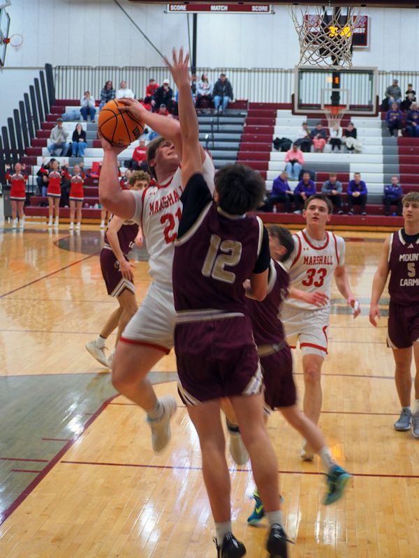 Garrett Pugh (21) takes an acrobatic shot in the LIC's 3rd place game against Mount Carmel