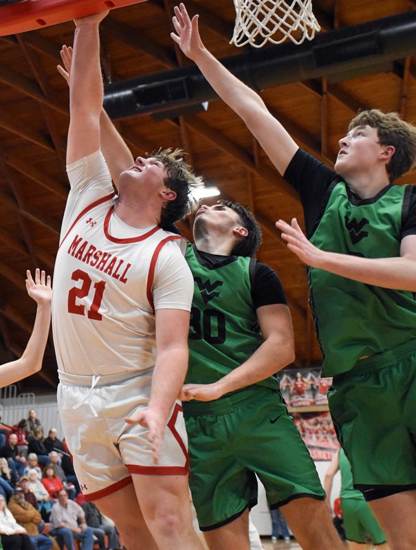 Garrett Pugh (21) powers through a Viking triple team to score for Marshall