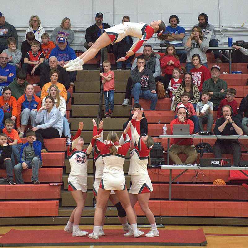 Marshall senior cheerleader Lexie Clark flies high over the crowd at halftime of the Marshall - Newton game