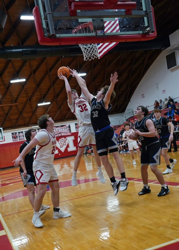 Zach Jones (32) goes up high over the Okaw Valley defense to score for Marshall