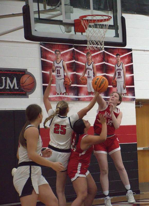 Marshall's Addy Ross (12) stuffs Edwards County's Lola Nussmeyer at the basket