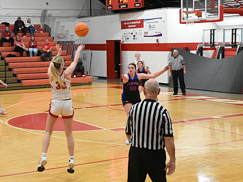 Marshall's Harper Richardson (32) banked home a 30-footer to beat the buzzer ending the third qtr against Newton