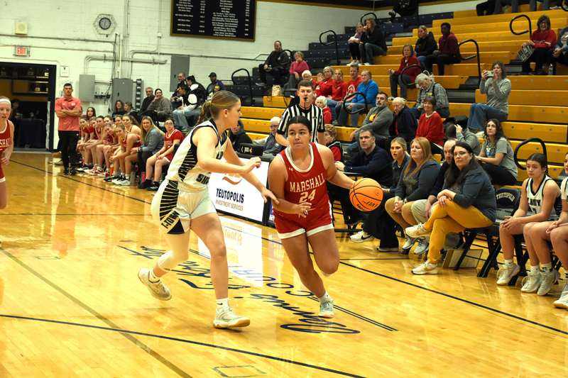 Marshall's Ella Mattas (24) dribble drives down the left side during the regional semifinal game