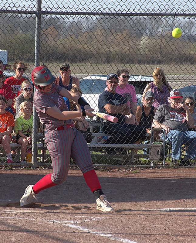 Klaire York launches a missle over the left field fence for a grand slam in Marshall'_s 14-2 win over Hutsonville-Palestine