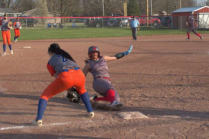 Caitlyn Hilliard slides safely into third base as Mollie Kent (background) races towards second