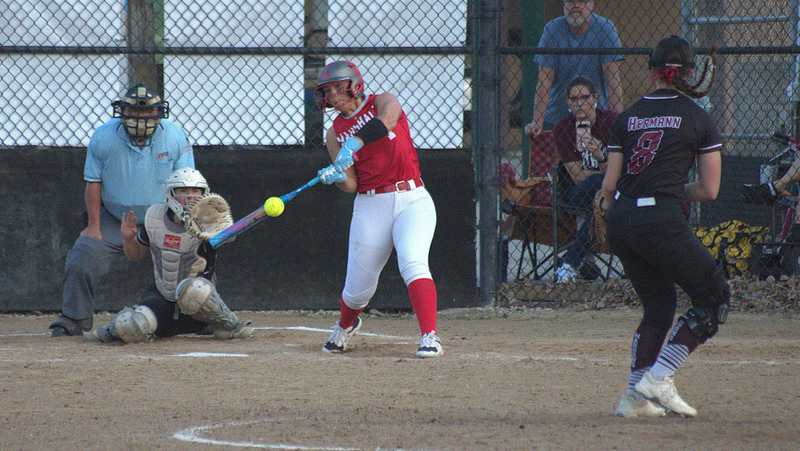 Caitlyn Hilliard (7) drives the pitch up the middle against Robinson