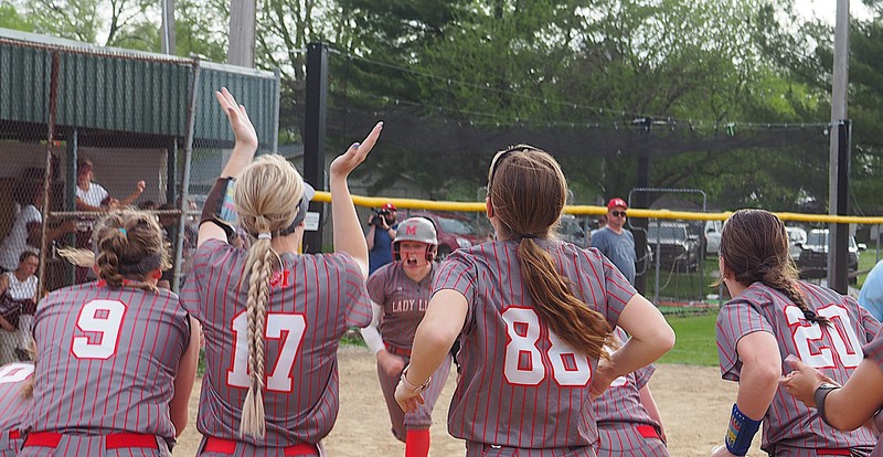 Lynn Welborn is greeted at home plate after her big blast against Robinson