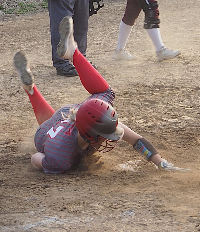 Avery Cornwell (17) slides home safely with what turned out to be the winning run of the game against Robinson