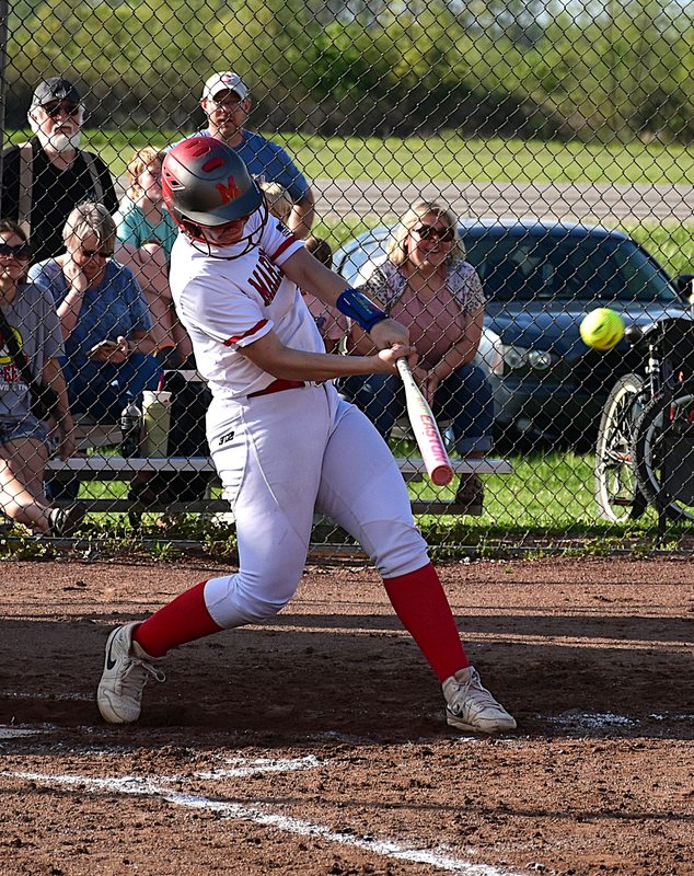 Klaire York sends this pitch into the sub-division across the street for a home run during Marshall's 10-0 win over Paris