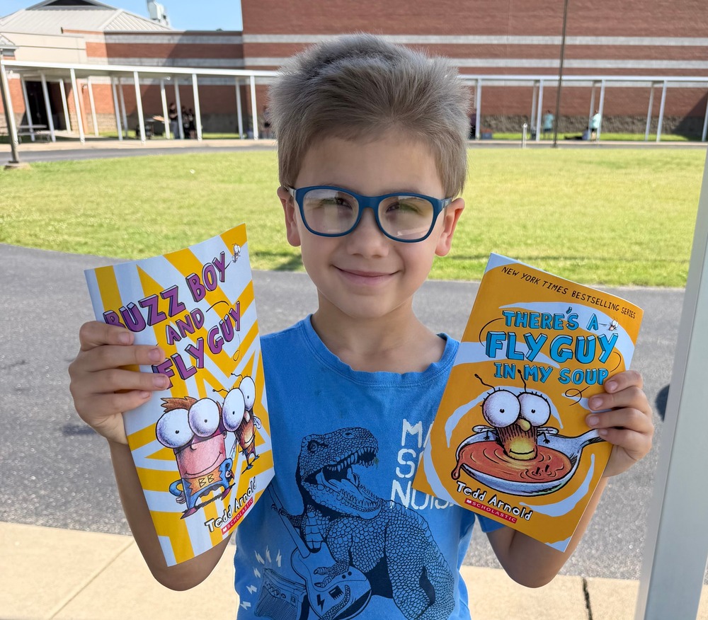 Student with books given away through reading grant