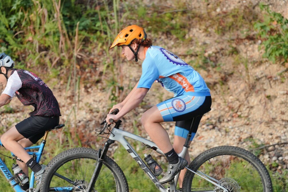 MC male mountain biker racing on trail