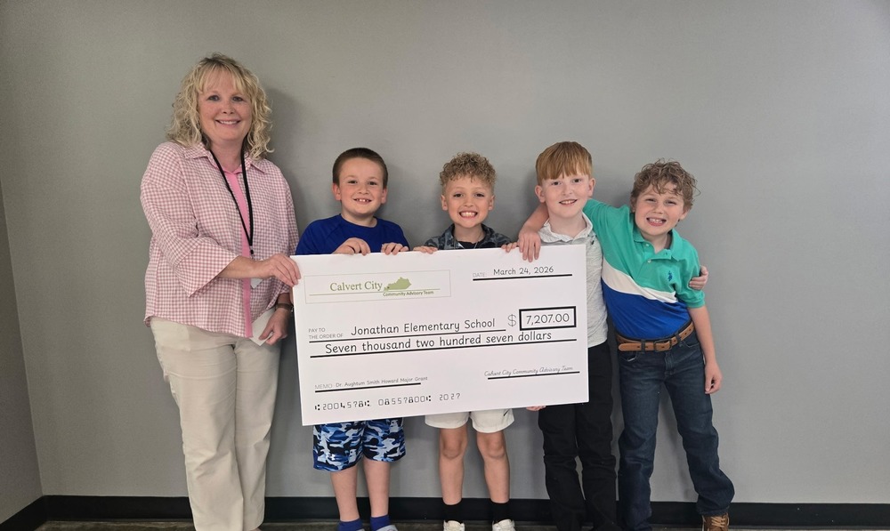 JES teacher and students holding cardboard check  from grant received from Calvert City Community Advisory Team