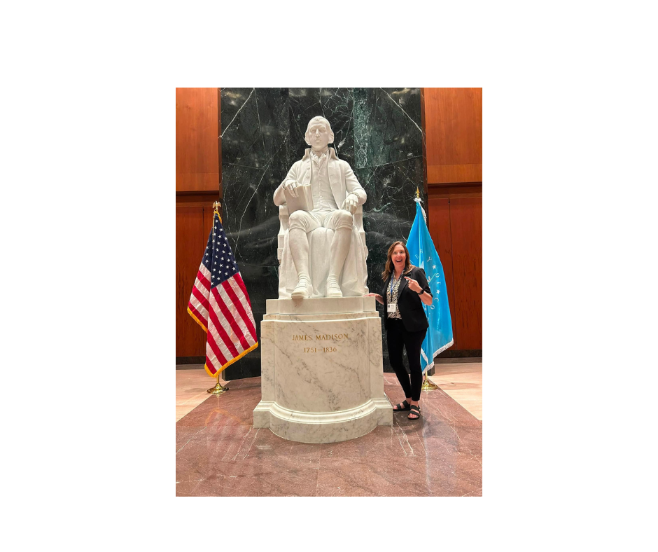 Rebecca Sealock beside statue of James Madison