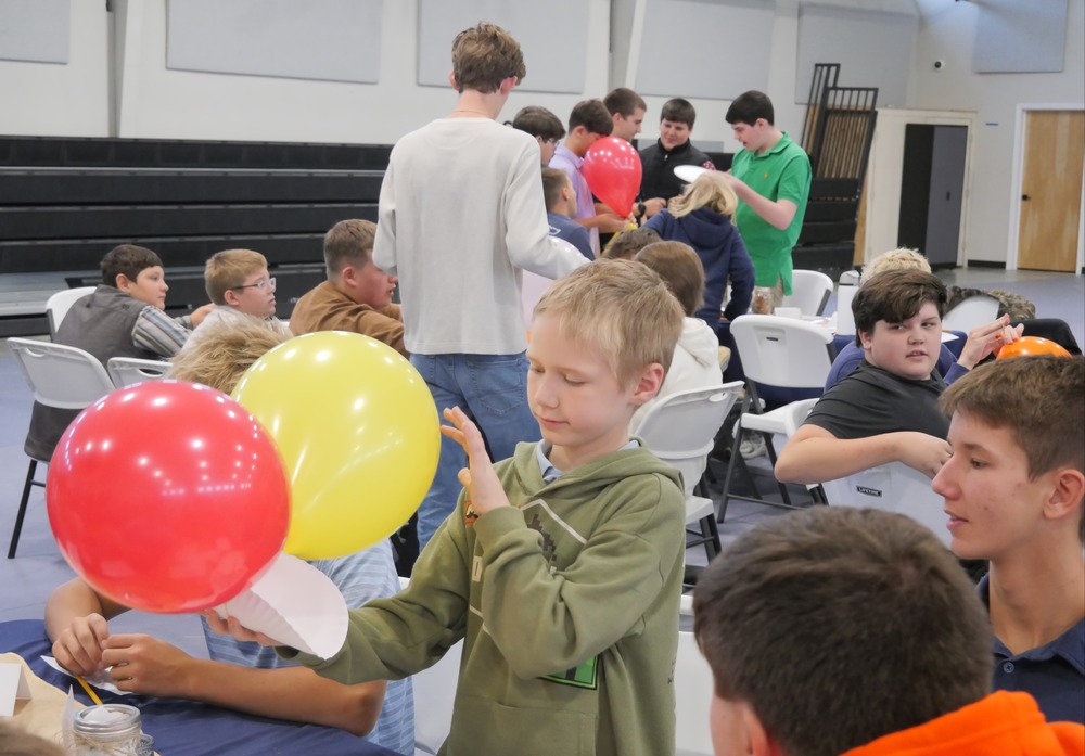 Marshall Male Conference attendees work on balloon project