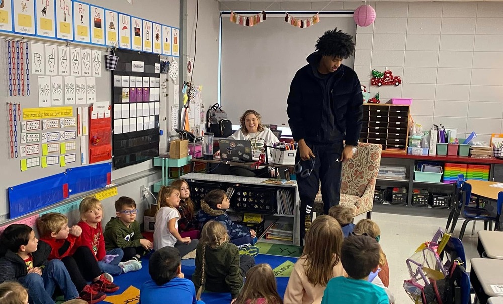 Link Academy player reads to BES students