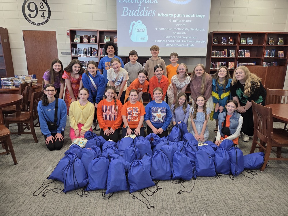 NMMS students with backpacks filled with hygiene and comfort items 